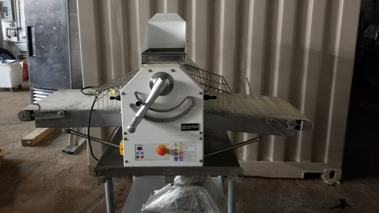 Doyon dough sheeter on stainless table in the warehouse