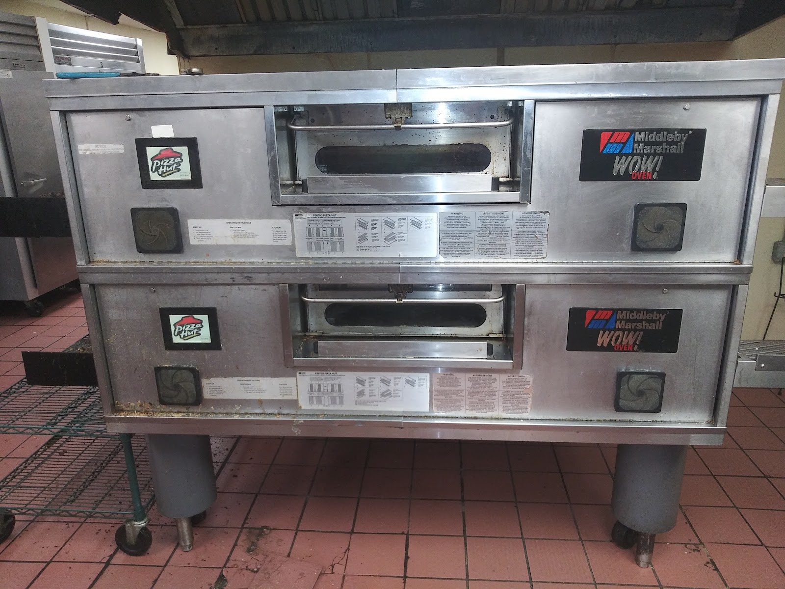 Stacked Middleby Marshall WOW conveyor pizza ovens on quarry tile